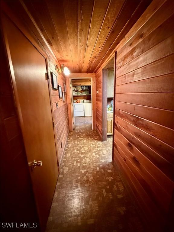 304 Flagler St, Clewiston, FL 33440 - hallway with separate washer and dryer, wood walls, and wooden ceiling