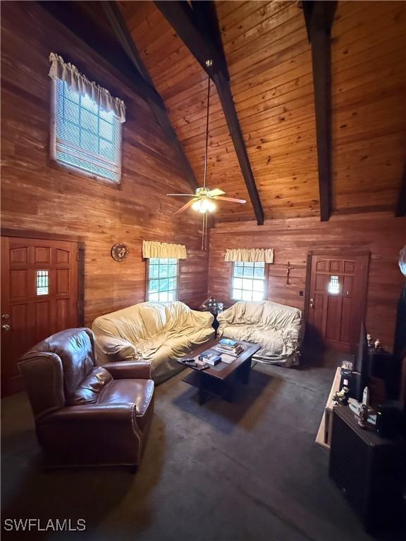 304 Flagler St, Clewiston, FL 33440 - living area with wood walls, beamed ceiling, ceiling fan, high vaulted ceiling, and wood ceiling