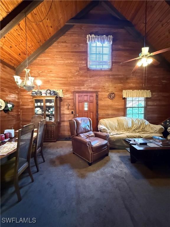 304 Flagler St, Clewiston, FL 33440 - living room featuring wood ceiling, wood walls, a ceiling fan, beam ceiling, and carpet flooring