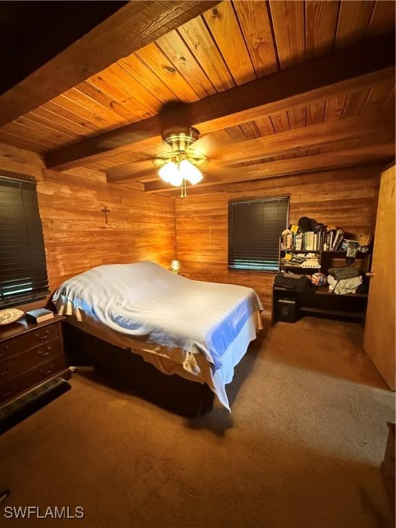 304 Flagler St, Clewiston, FL 33440 - carpeted bedroom with wood ceiling, wooden walls, and beam ceiling