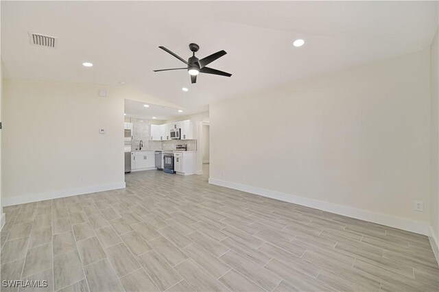 4733/4735 28th St SW, Lehigh Acres, FL 33973 - unfurnished living room featuring ceiling fan, baseboards, recessed lighting, light wood finished floors, and vaulted ceiling