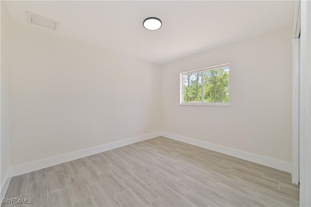 4733/4735 28th St SW, Lehigh Acres, FL 33973 - spare room featuring light wood finished floors and baseboards