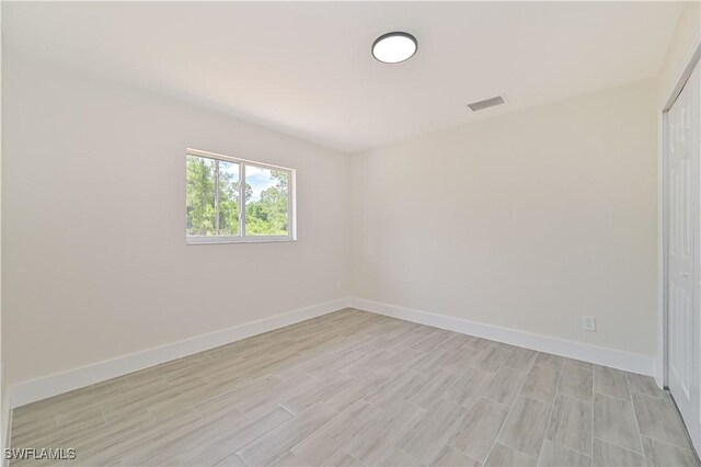 4733/4735 28th St SW, Lehigh Acres, FL 33973 - unfurnished room featuring baseboards and light wood-type flooring