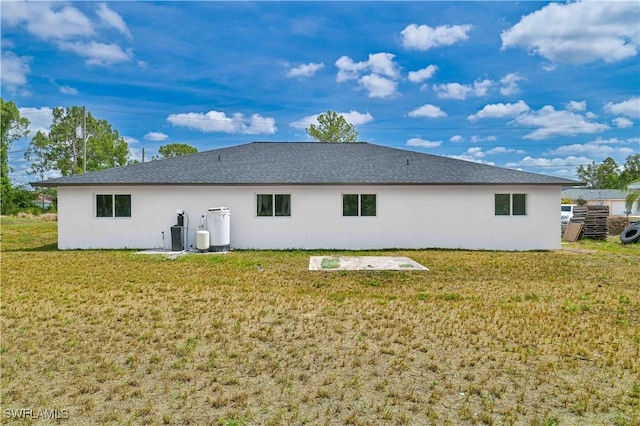 4733/4735 28th St SW, Lehigh Acres, FL 33973 - rear view of property with stucco siding and a yard