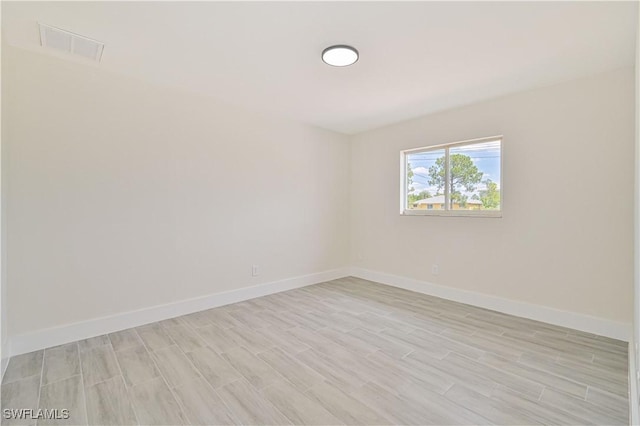 4733/4735 28th St SW, Lehigh Acres, FL 33973 - unfurnished room with light wood-style floors and baseboards