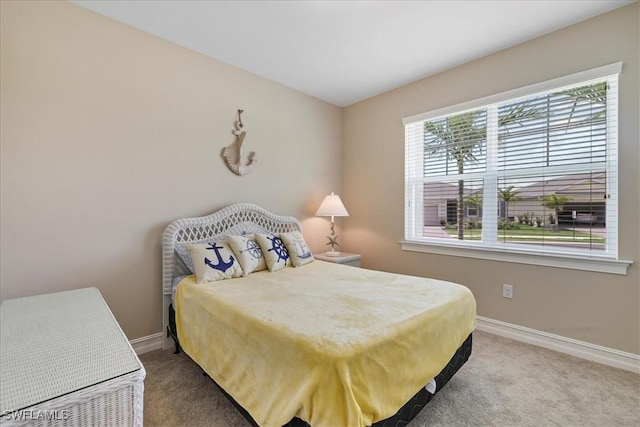 bedroom with carpet and baseboards