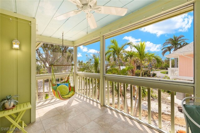 sunroom / solarium with ceiling fan and healthy amount of natural light