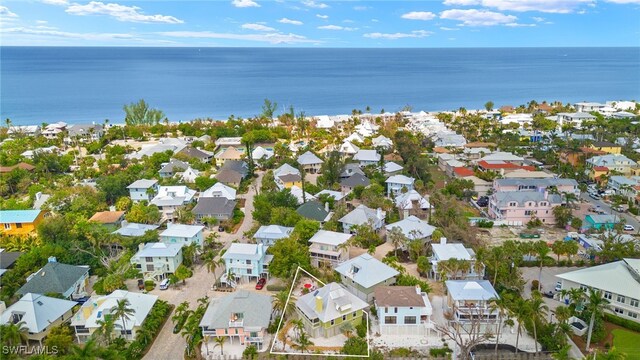 aerial overview of property's location featuring nearby suburban area and a nearby body of water