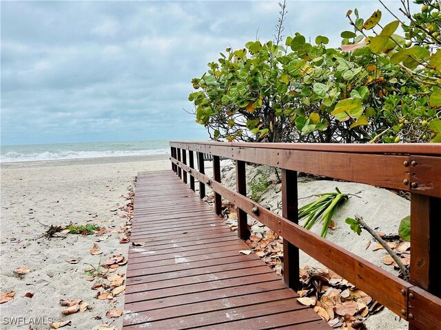 view of home's community featuring view of water and beach