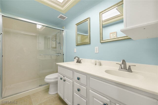 full bathroom featuring toilet, a shower stall, double vanity, and tile patterned floors