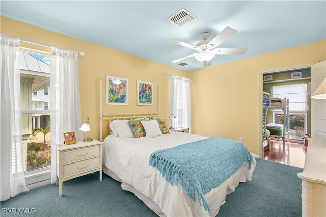bedroom with multiple windows and a ceiling fan