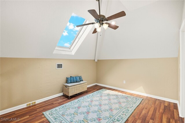 bonus room featuring lofted ceiling, ceiling fan, a skylight, wood finished floors, and baseboards