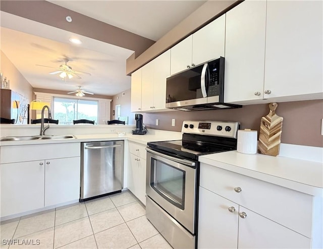 kitchen with stainless steel appliances, a sink, light countertops, a ceiling fan, and recessed lighting