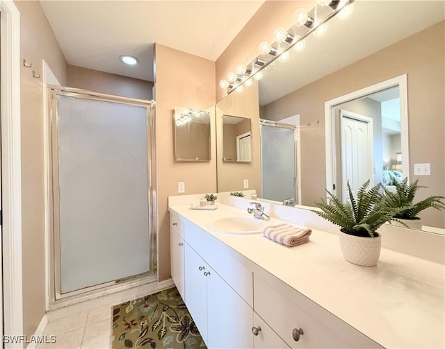 full bathroom featuring a stall shower, vanity, baseboards, tile patterned flooring, and recessed lighting