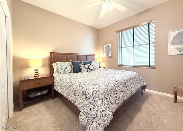 bedroom featuring light carpet, baseboards, and ceiling fan
