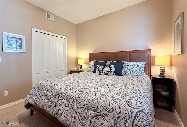 carpeted bedroom with a closet and baseboards