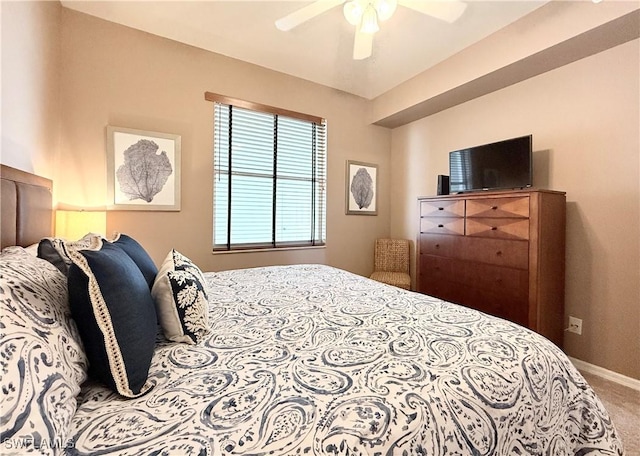 carpeted bedroom with baseboards and a ceiling fan