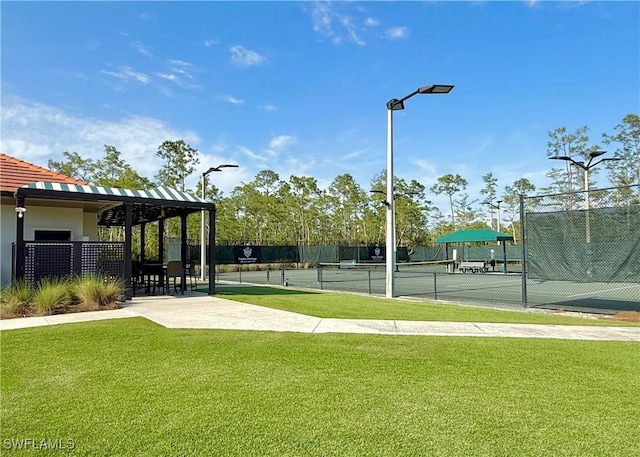 view of property's community featuring a tennis court