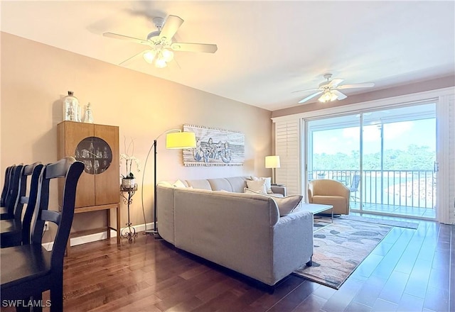 living room featuring a ceiling fan and dark wood finished floors