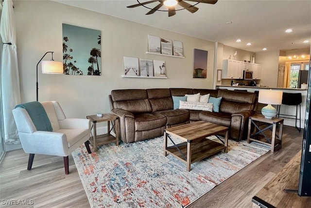 living area with a ceiling fan, light wood-style floors, and recessed lighting
