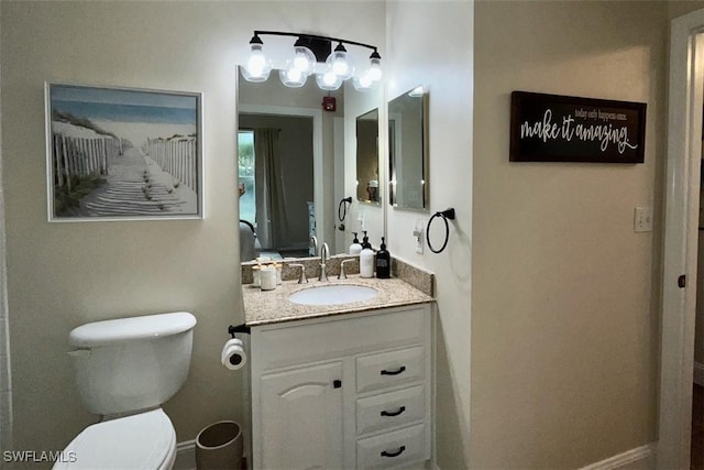 bathroom featuring vanity and toilet
