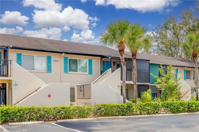 4200 Looking Glass Ln Unit 4206, Naples, FL 34112 - view of front of property with stucco siding and uncovered parking
