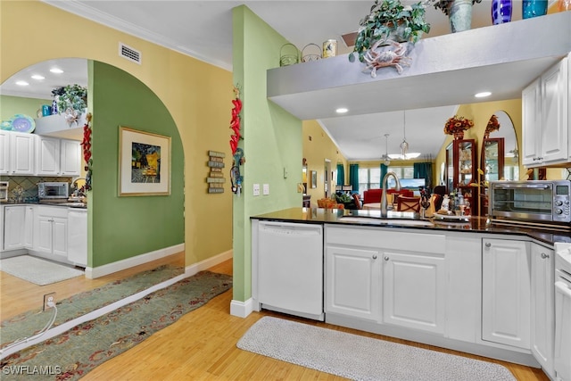 4200 Looking Glass Ln Unit 4206, Naples, FL 34112 - kitchen with white dishwasher, a sink, light wood-type flooring, white cabinets, and dark countertops