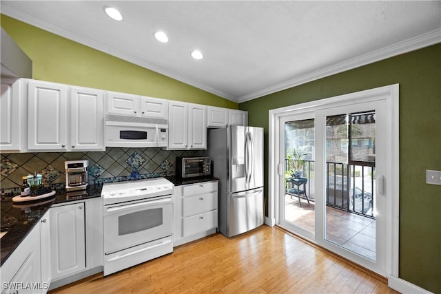4200 Looking Glass Ln Unit 4206, Naples, FL 34112 - kitchen with white appliances, lofted ceiling, decorative backsplash, crown molding, and dark countertops