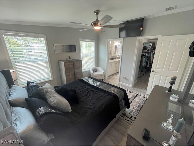 5570 Cypresswoods Resort Dr, Fort Myers, FL 33905 - bedroom featuring ornamental molding, light wood-style floors, a spacious closet, connected bathroom, and a closet