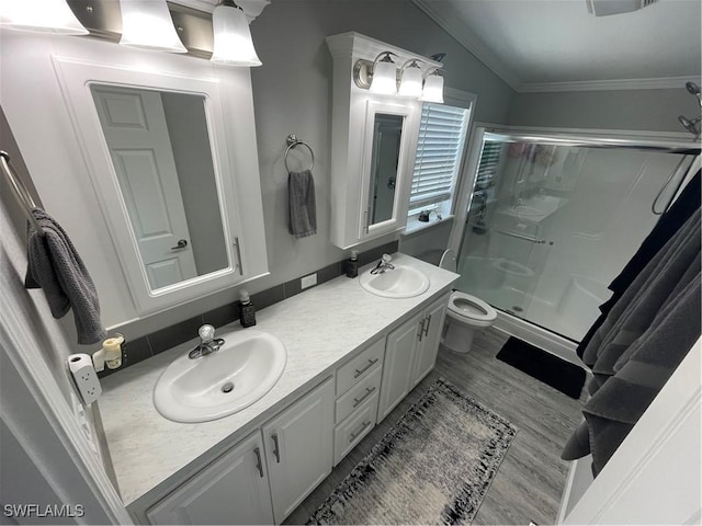 5570 Cypresswoods Resort Dr, Fort Myers, FL 33905 - bathroom with toilet, a stall shower, ornamental molding, double vanity, and wood finished floors