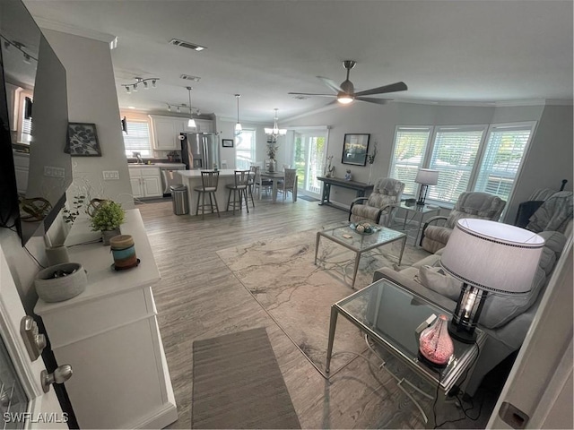 5570 Cypresswoods Resort Dr, Fort Myers, FL 33905 - living room featuring crown molding, a ceiling fan, light wood-style floors, and healthy amount of natural light