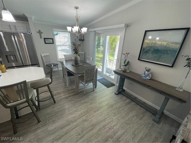5570 Cypresswoods Resort Dr, Fort Myers, FL 33905 - dining room featuring light wood finished floors, crown molding, a chandelier, and baseboards
