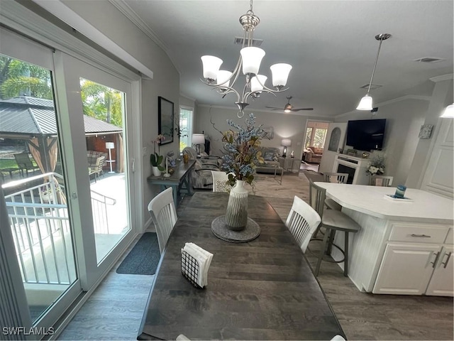 5570 Cypresswoods Resort Dr, Fort Myers, FL 33905 - dining space with wood finished floors, ceiling fan, crown molding, and a chandelier
