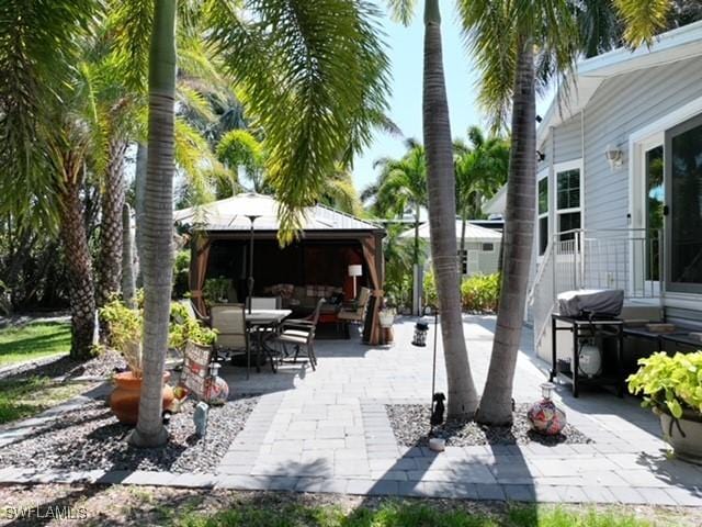 5570 Cypresswoods Resort Dr, Fort Myers, FL 33905 - view of patio / terrace with a gazebo, outdoor dining area, and area for grilling