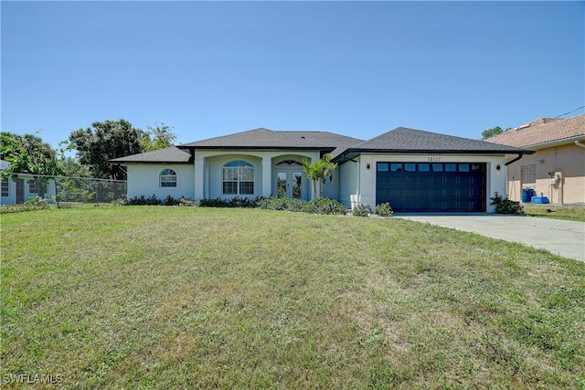 view of front facade with an attached garage, driveway, stucco siding, and french doors