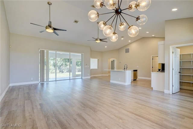 unfurnished living room featuring ceiling fan, baseboards, a chandelier, light wood-style floors, and recessed lighting