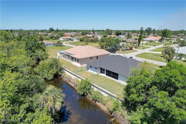 aerial view of residential area with a large body of water