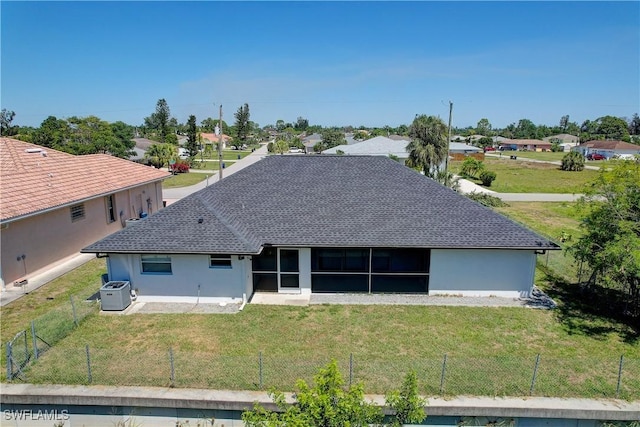 rear view of property with central air condition unit, a shingled roof, a sunroom, stucco siding, and a residential view