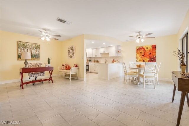dining area featuring ceiling fan, light tile patterned floors, and baseboards