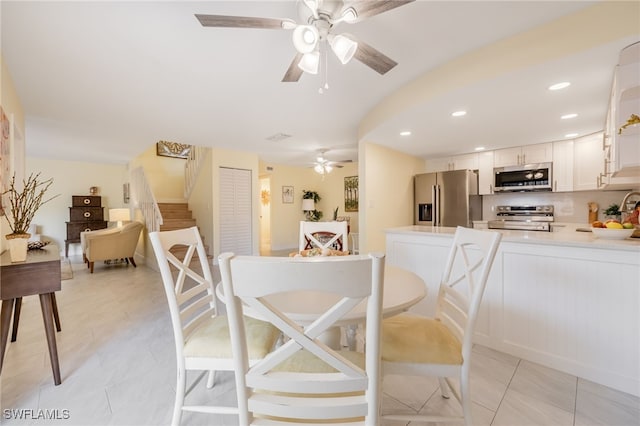 dining space with ceiling fan, light tile patterned floors, recessed lighting, and stairs