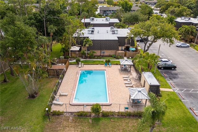 community pool with a gazebo and fence
