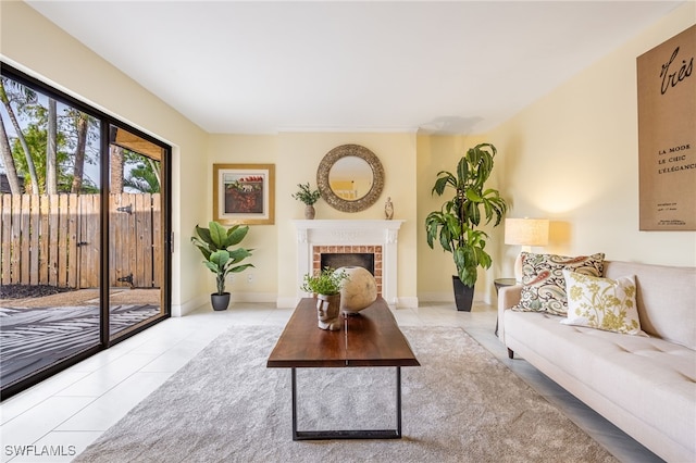 tiled living room featuring a fireplace and baseboards