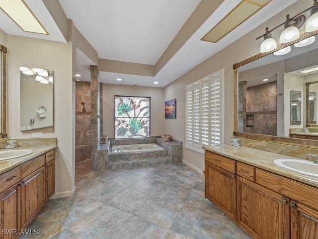 bathroom with a walk in shower, a garden tub, baseboards, two vanities, and recessed lighting