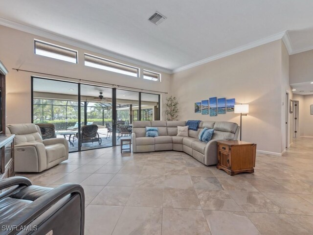 living area with crown molding and baseboards
