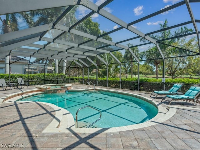 view of swimming pool featuring a patio, a pool with connected hot tub, and glass enclosure