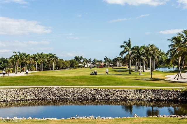 view of property's community featuring golf course view, a water view, and a lawn