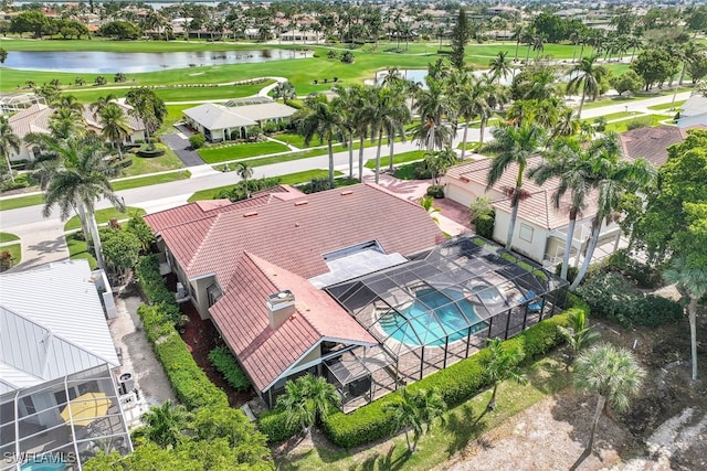 aerial perspective of suburban area with a golf course, a large body of water, and a pool area