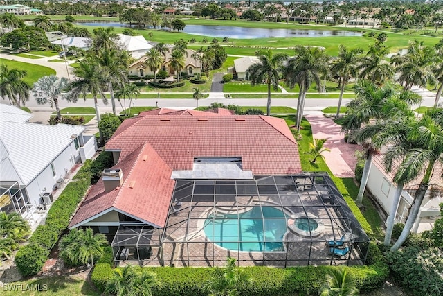 aerial view of residential area with a pool, a nearby body of water, and a local golf course