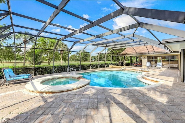 view of pool featuring a pool with connected hot tub, a patio area, and a lanai