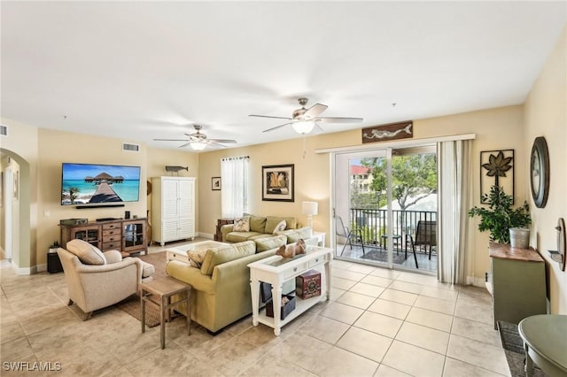 1520 SW 50th St Unit 202, Cape Coral, FL 33914 - living room featuring arched walkways, light tile patterned floors, ceiling fan, and baseboards
